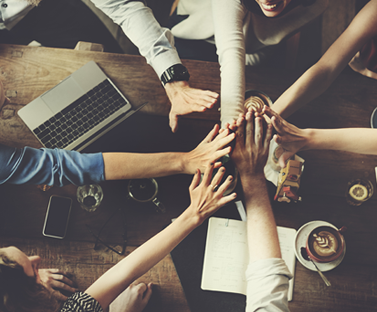2378_z_pro-bono-1 Gruppo di professionisti riuniti intorno a tavolo in lavoro collaborativo pro bono