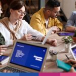 Riunione di lavoro in team su disciplina IVA enti associativi con documenti e laptop